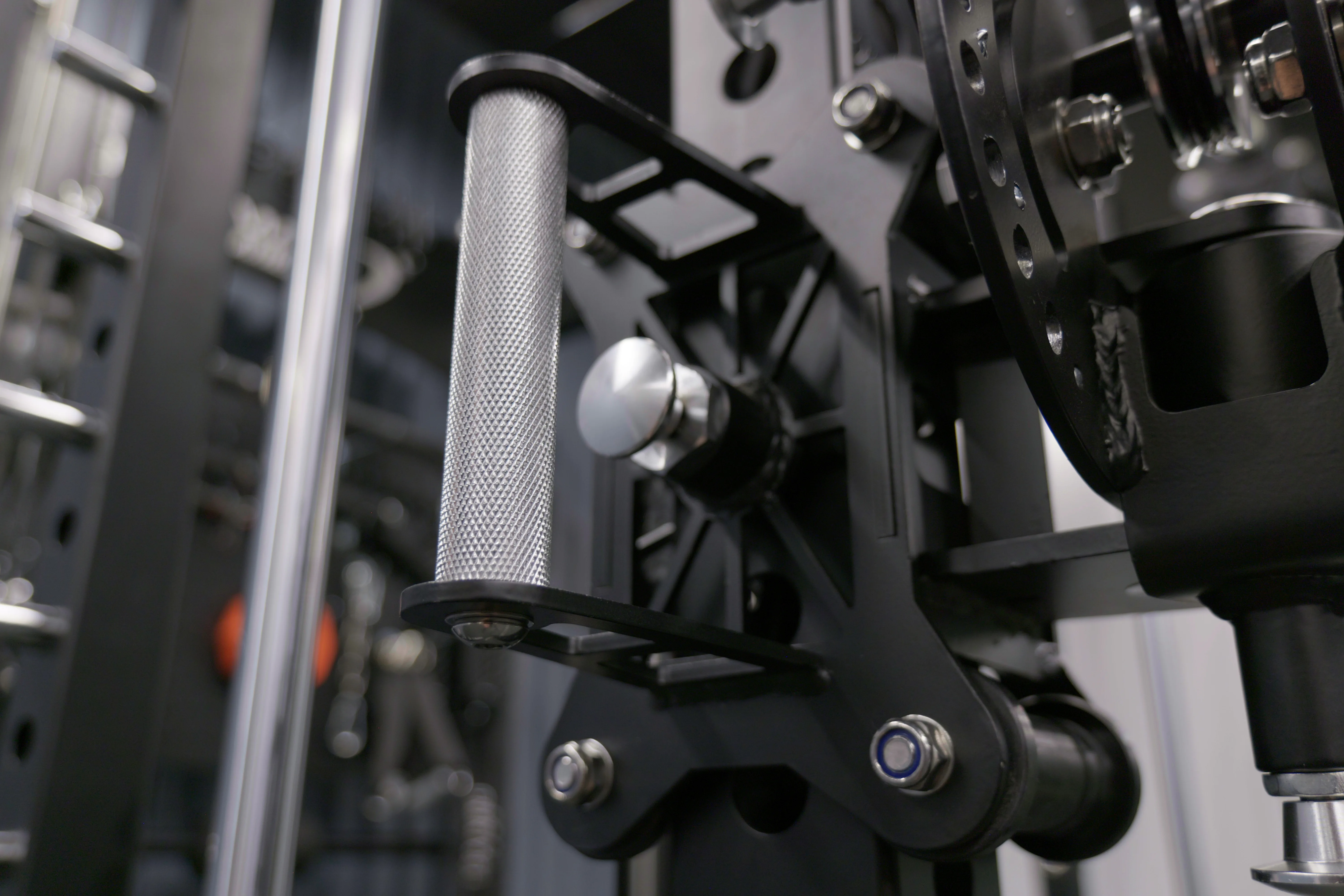 Macro detail of the Everest's knurled cable handle and trolley hardware with oversized bolts and clean welds.