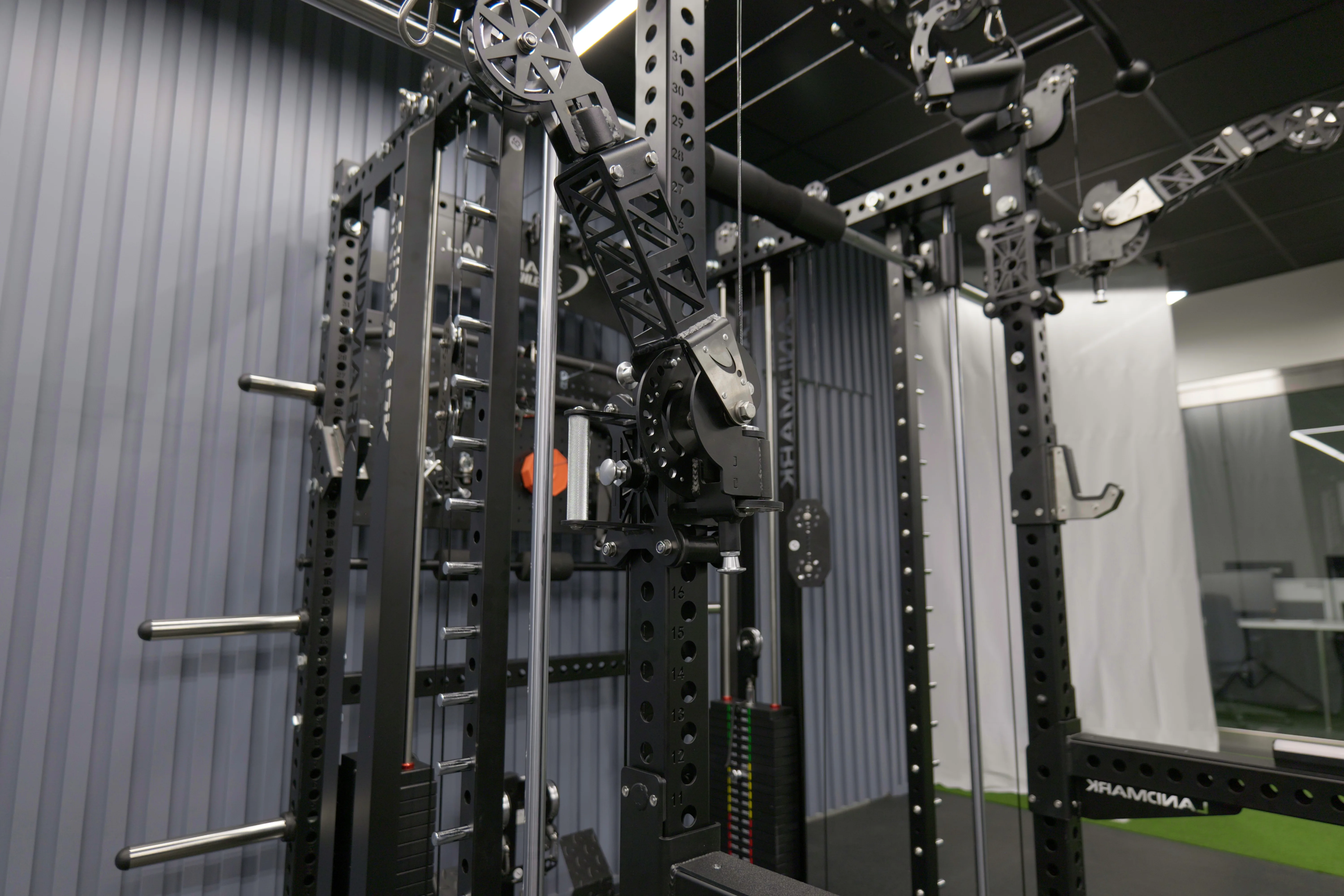 Angled view of the Everest frame showing a pivot arm mounted on the numbered upright, weight stack, and rear pegboard.