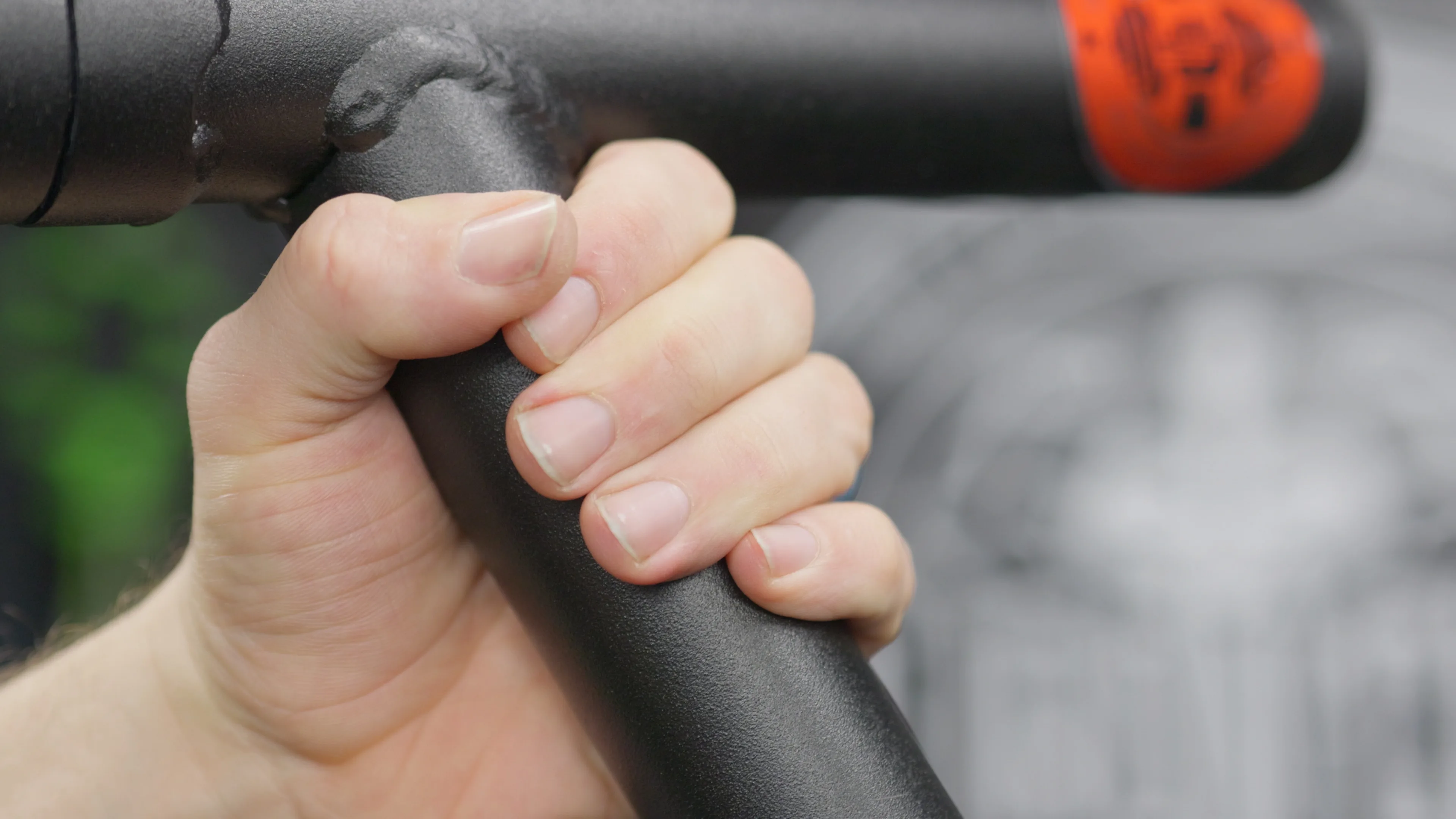 Hand gripping the LPG Muscle Boar Tusk cable attachment